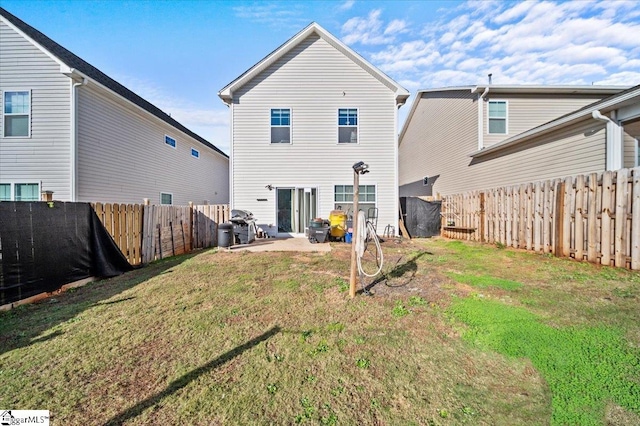 rear view of house with a yard