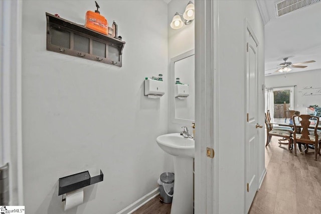 bathroom featuring wood-type flooring, ceiling fan, and sink