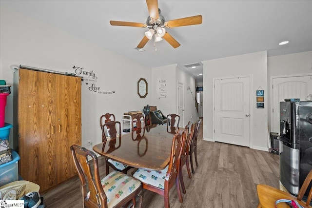 dining room with hardwood / wood-style floors and ceiling fan