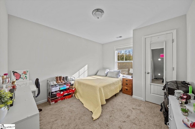 bedroom featuring light colored carpet