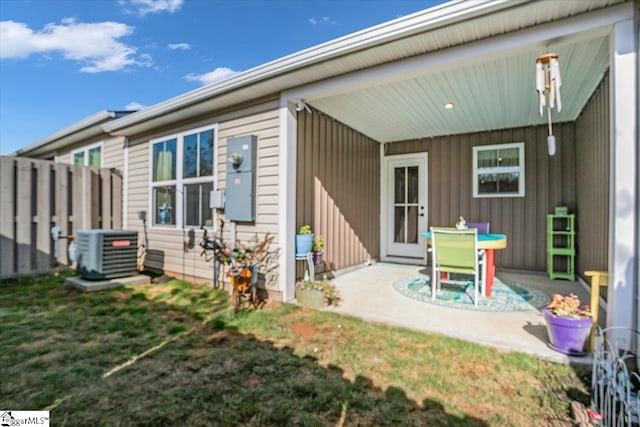 back of house featuring central air condition unit, a patio, and a yard