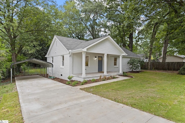 bungalow-style house with covered porch, a front yard, and a carport