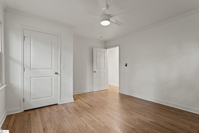 unfurnished bedroom featuring ceiling fan, light wood-type flooring, and ornamental molding