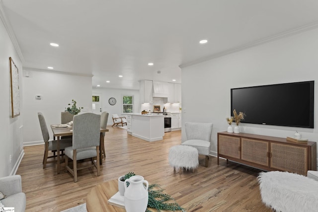 living room with light hardwood / wood-style floors and ornamental molding