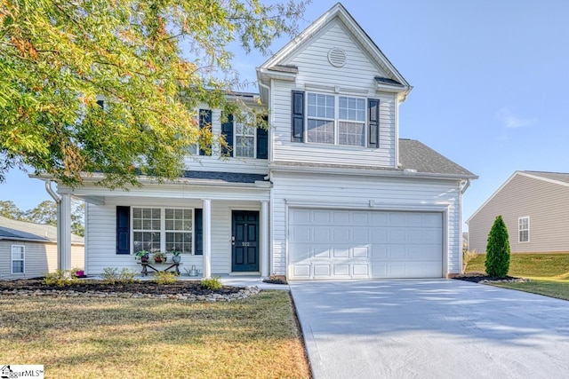 view of front property featuring a garage and a front lawn