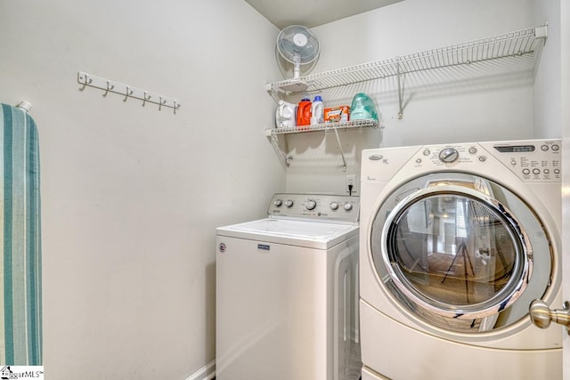 laundry area with washing machine and clothes dryer