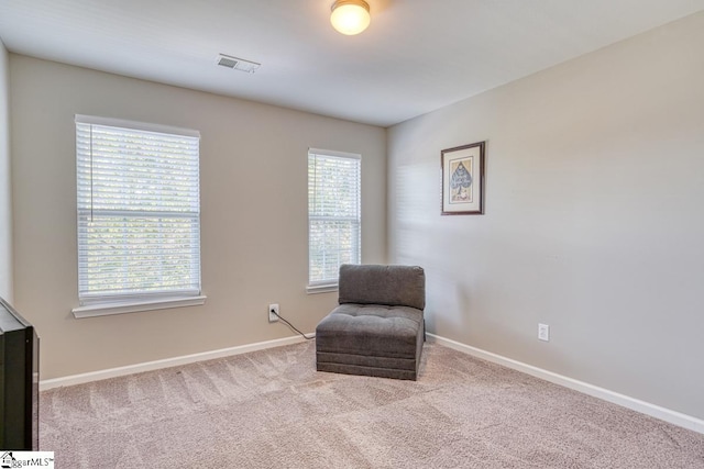 sitting room with light colored carpet