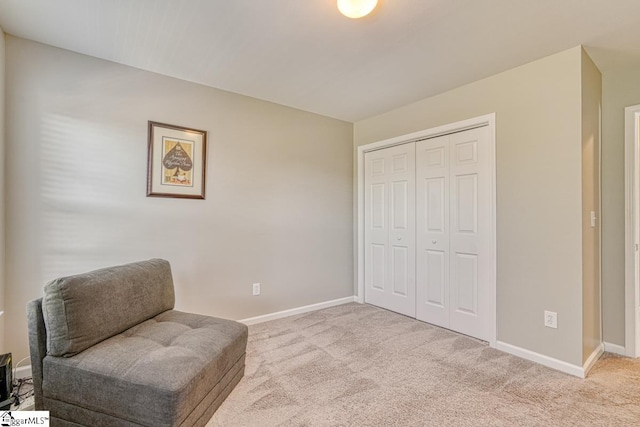 sitting room featuring light carpet