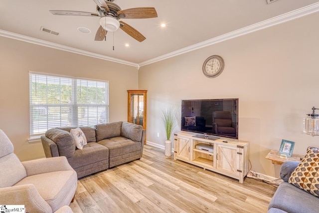 living room with light hardwood / wood-style flooring, ceiling fan, and ornamental molding