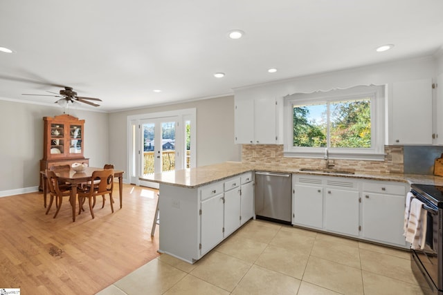 kitchen featuring kitchen peninsula, stainless steel dishwasher, plenty of natural light, and sink