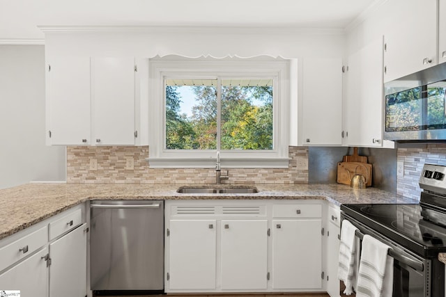 kitchen featuring white cabinets, decorative backsplash, stainless steel appliances, and sink