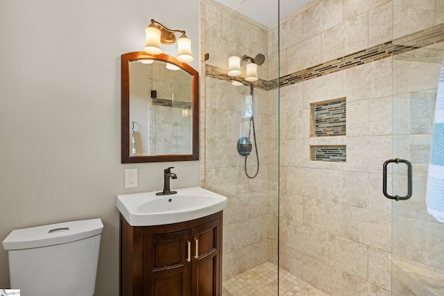 bathroom featuring vanity, toilet, and walk in shower