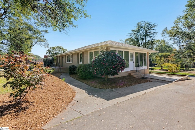 view of front of home featuring a sunroom