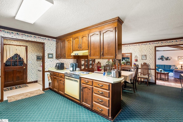 kitchen with a textured ceiling, kitchen peninsula, dark carpet, and white range