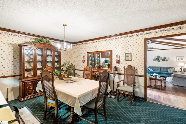 dining area featuring a textured ceiling, an inviting chandelier, and crown molding