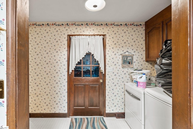 washroom with cabinets, light tile patterned flooring, and washing machine and clothes dryer