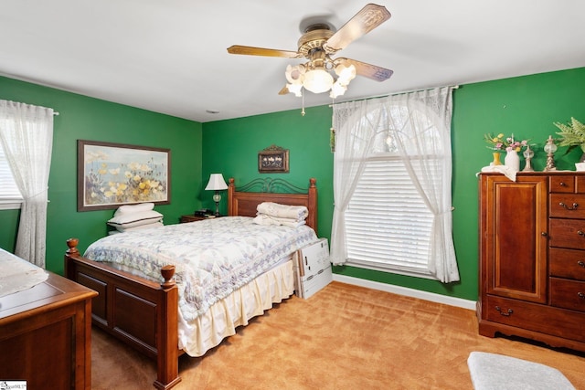 bedroom featuring ceiling fan and light carpet