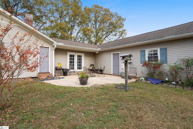 back of house featuring a yard, a patio, and french doors