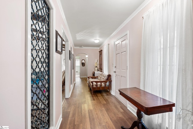 corridor with crown molding and hardwood / wood-style floors