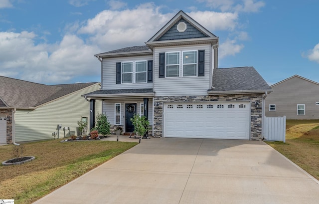 view of front of home featuring a front yard and a garage