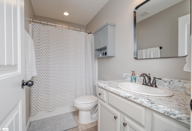 bathroom featuring tile patterned floors, vanity, and toilet