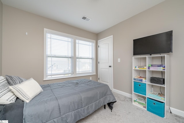 bedroom featuring light carpet