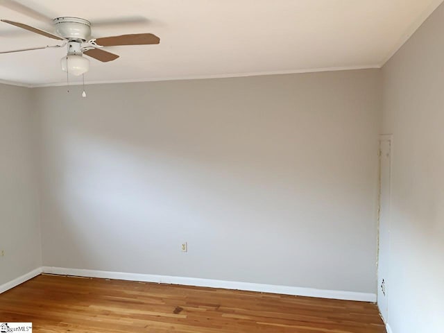 empty room with hardwood / wood-style flooring, ceiling fan, and crown molding