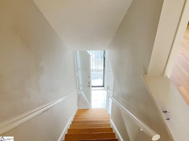 stairs with hardwood / wood-style flooring