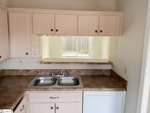 kitchen featuring light brown cabinets, white dishwasher, and sink