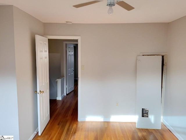 spare room featuring hardwood / wood-style flooring and ceiling fan