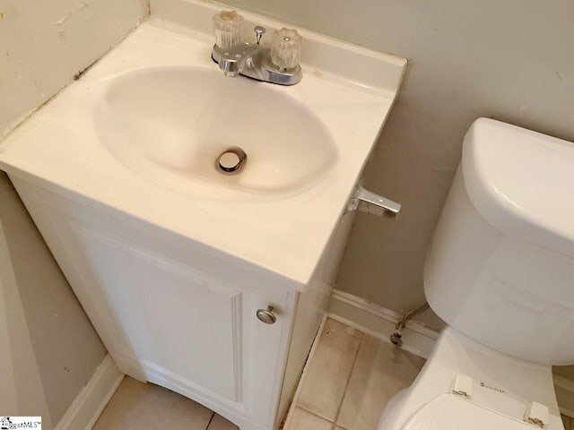 bathroom with tile patterned flooring, vanity, and toilet