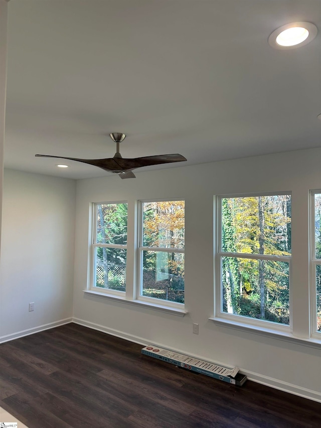 spare room featuring dark hardwood / wood-style floors and ceiling fan