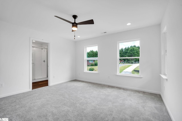 carpeted spare room featuring ceiling fan