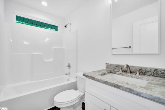 full bathroom featuring washtub / shower combination, vanity, and toilet