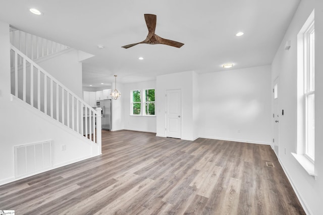 unfurnished living room with light hardwood / wood-style floors and ceiling fan