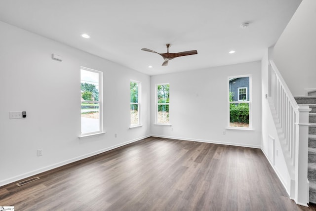 empty room featuring ceiling fan and dark hardwood / wood-style floors