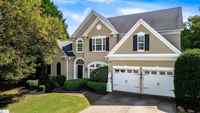 view of front of home featuring a garage and a front lawn