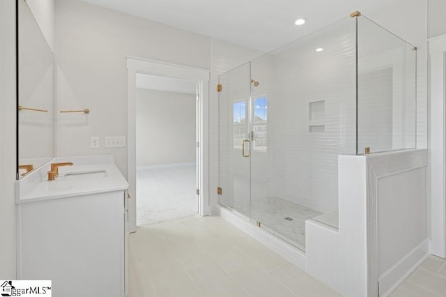 bathroom featuring vanity, recessed lighting, and a stall shower