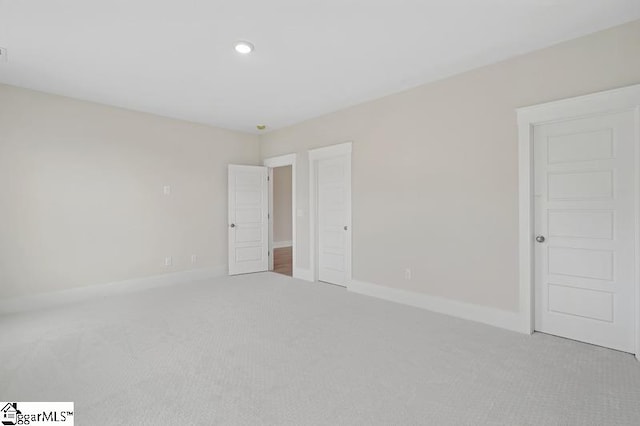 unfurnished bedroom featuring recessed lighting, baseboards, and carpet