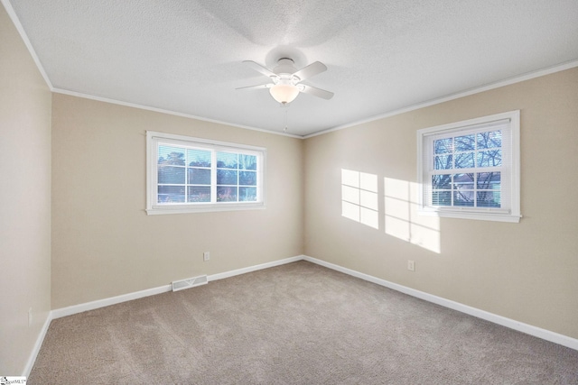 empty room featuring carpet flooring, ceiling fan, crown molding, and a textured ceiling