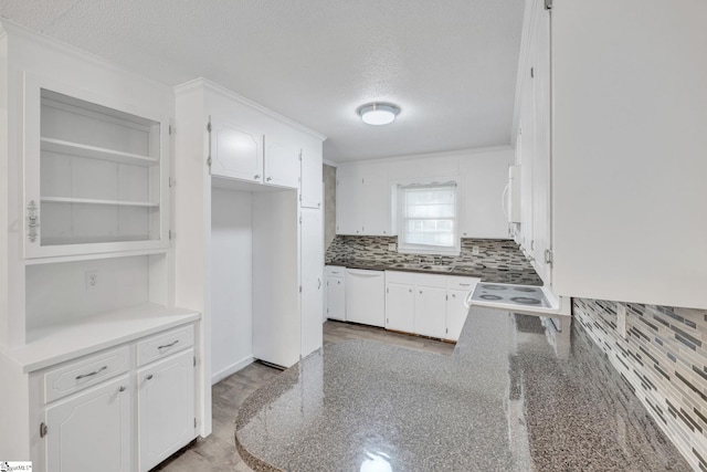 kitchen featuring backsplash, white cabinetry, a textured ceiling, and white appliances