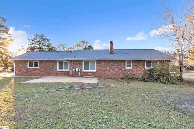 back of house featuring a patio and a lawn