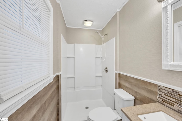 bathroom with toilet, vanity, tile walls, and ornamental molding