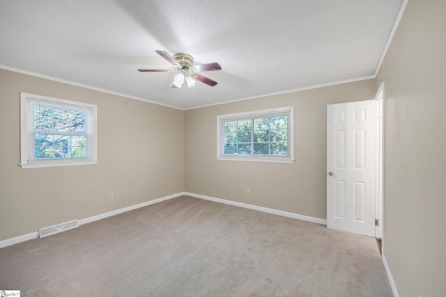 carpeted empty room with a textured ceiling, ceiling fan, and ornamental molding