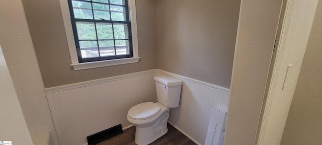 bathroom featuring hardwood / wood-style floors and toilet