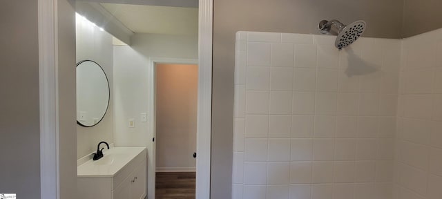 bathroom featuring hardwood / wood-style floors, vanity, and walk in shower