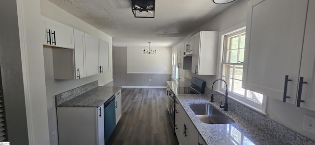 kitchen with plenty of natural light, white cabinetry, sink, and decorative light fixtures