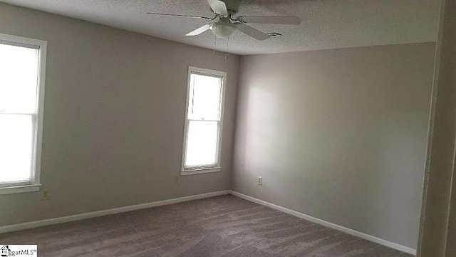 spare room featuring a textured ceiling, carpet floors, and ceiling fan