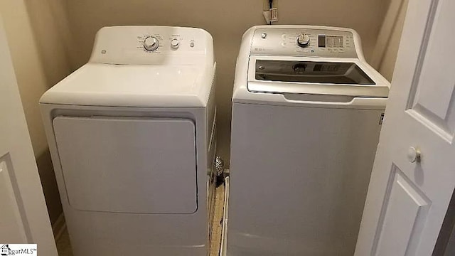 clothes washing area featuring independent washer and dryer