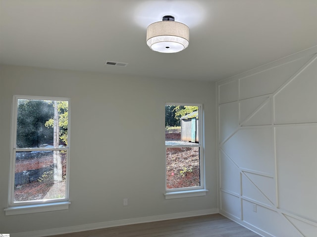 spare room featuring hardwood / wood-style floors and a wealth of natural light